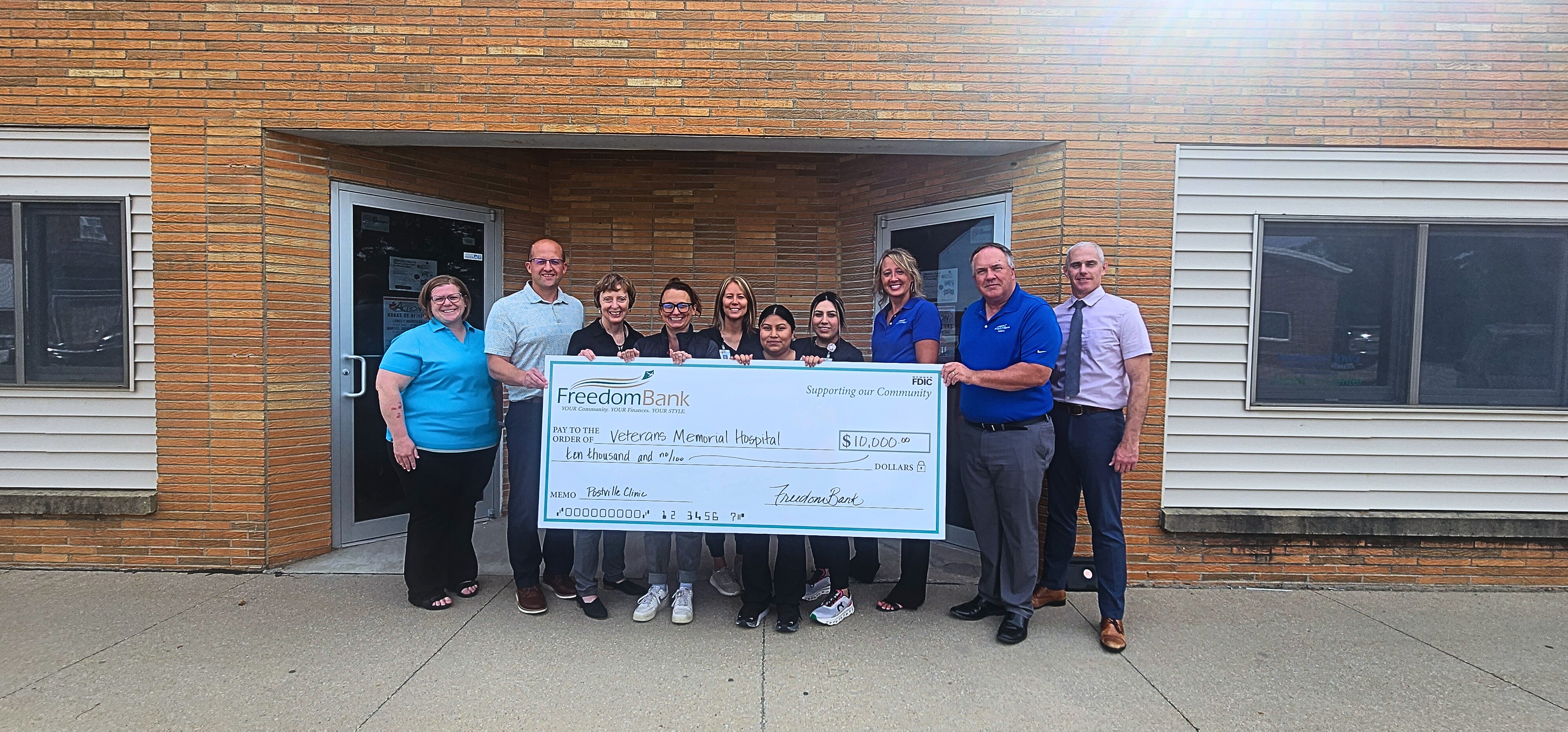 Picture of FreedomBank employees and VMH Postville Clinic Employees with a big check made out to them